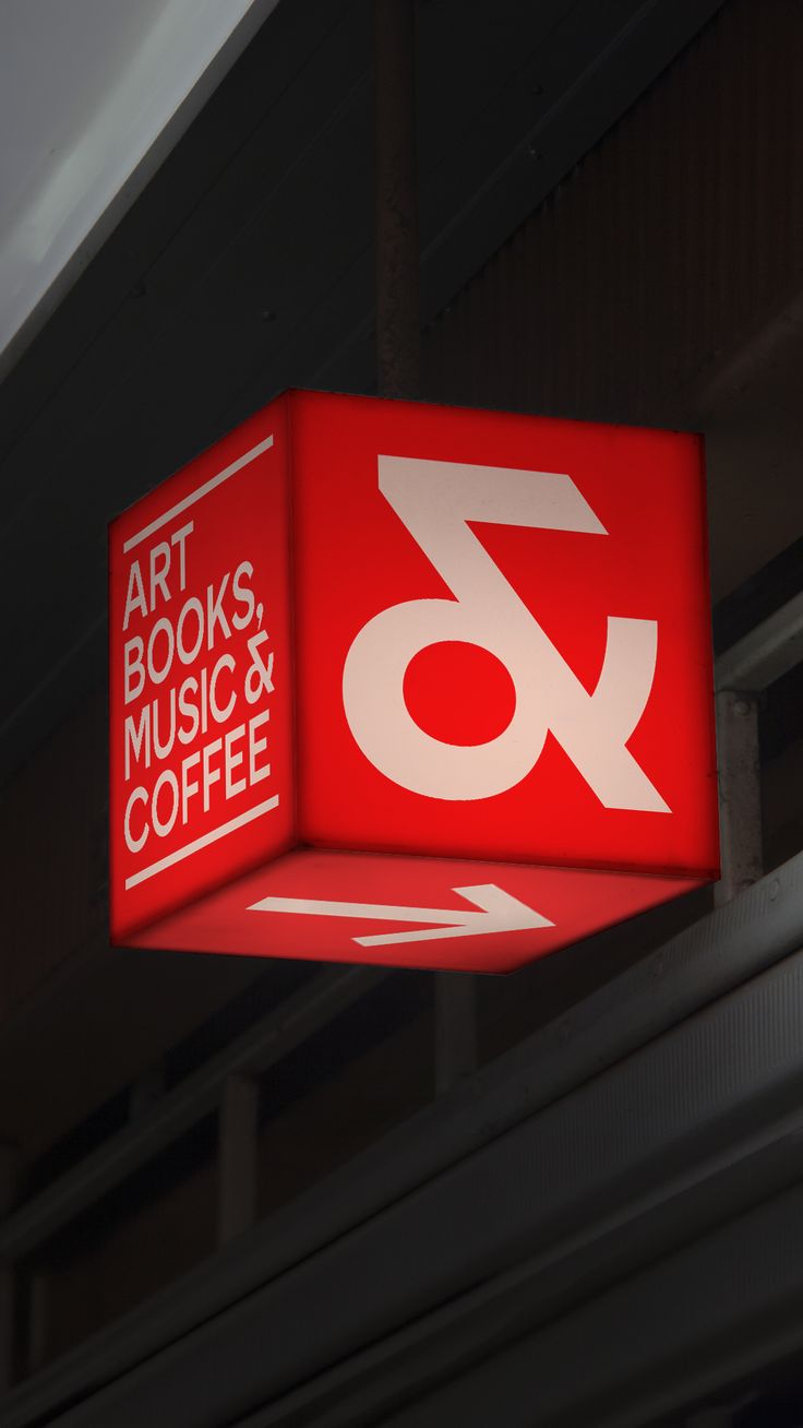 Custom cube-shaped illuminated sign in a retail setting