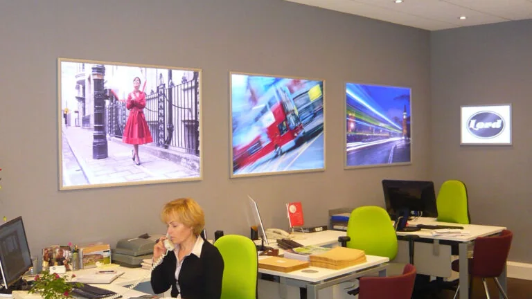 Slimline illuminated poster light boxes installed in an office